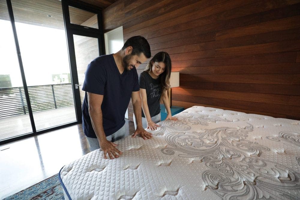 Couple touching mattress