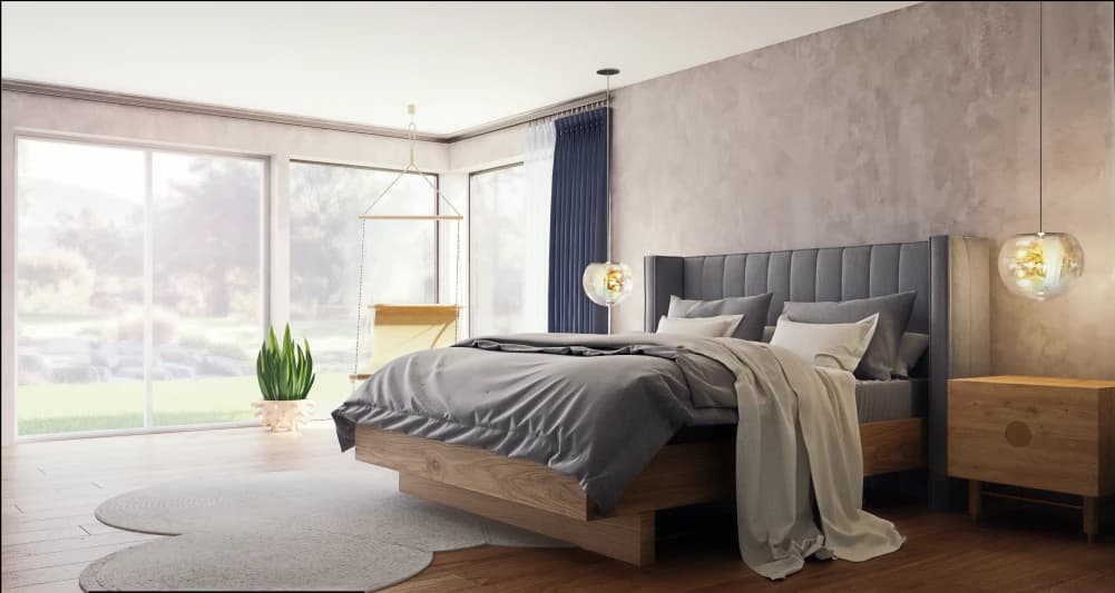 Bed with gray headboard with channeling design, gray and white sheets with gray and white pillows in a well-lit room