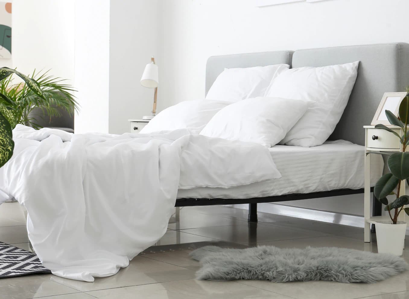 bed with white sheets and pillows