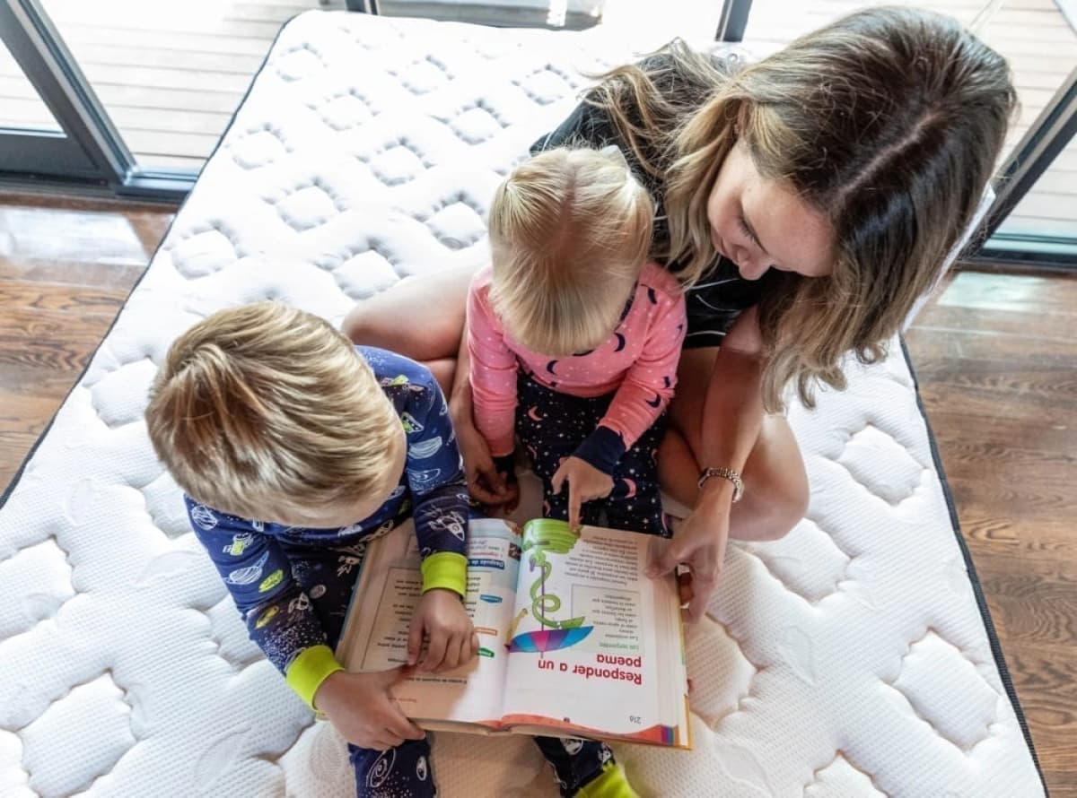 Family reading on mattress