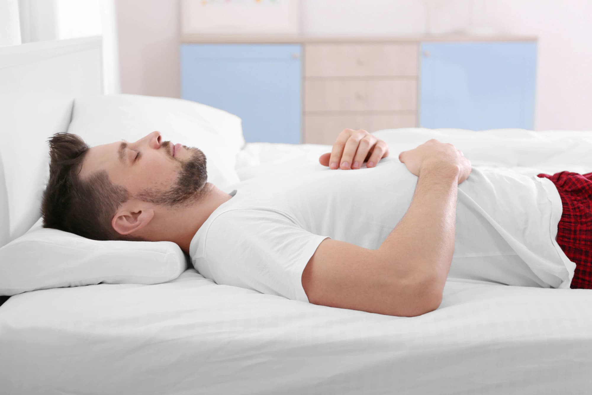 Man lying on his back on a mattress