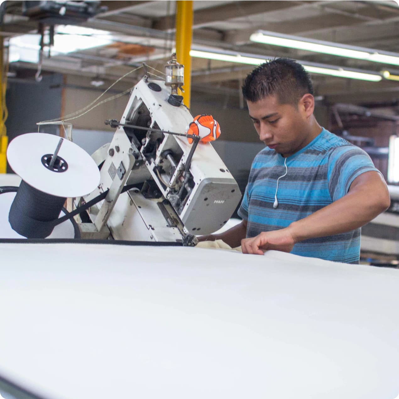 Factory worker making a mattress