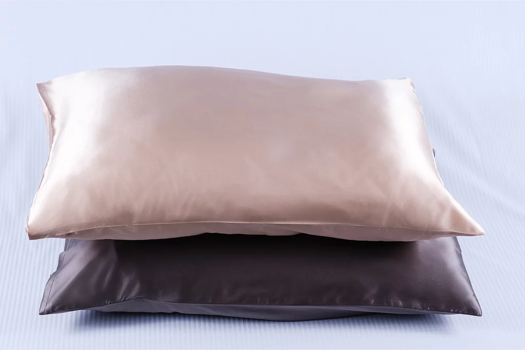 Two pillows with silk pillowcases.