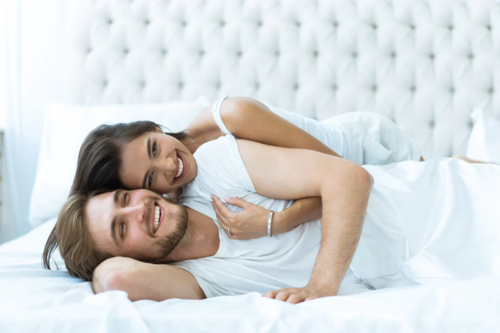 Smiling couple on bed